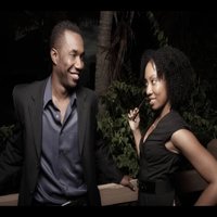 black woman looking flirtatiously at a black man, who's smiling at her