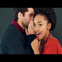 gossiping couple with man whispering in shocked woman's ear