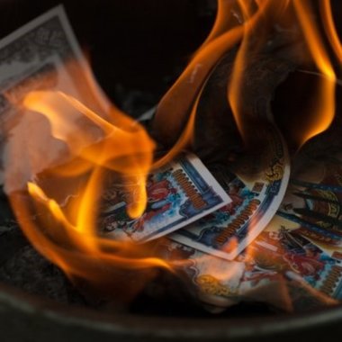 colored joss paper notes burning with orange flames