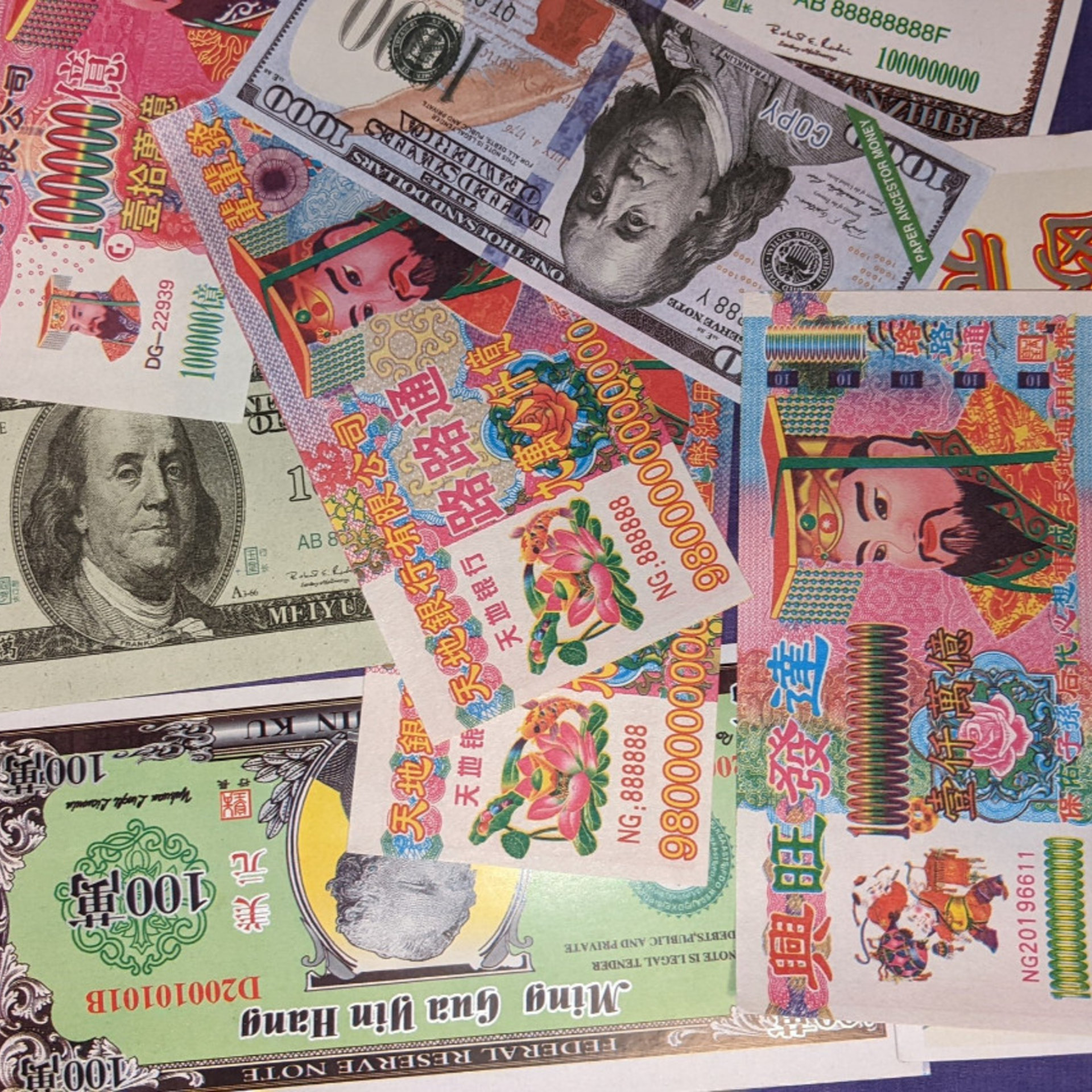 various colored joss paper notes spread out in a pile on a purple background